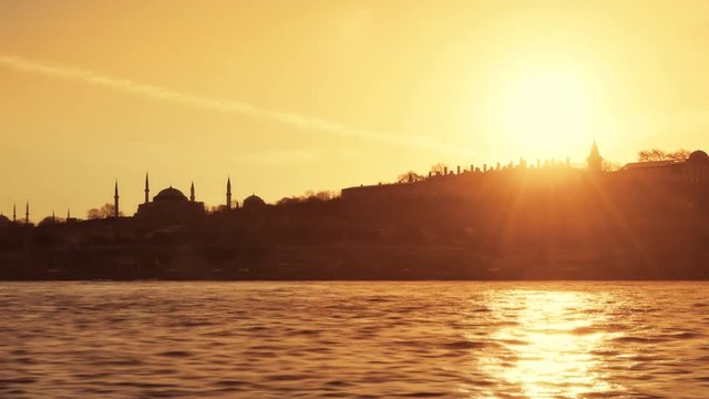 Old Istanbul at Sunset. Panning right to left historical landmarks; Topkapi Palace, Hagia Sophia and Blue Mosque under the evening sun. 4K, Slow Motion