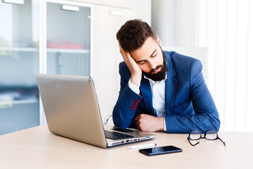 Young Sleepy Designer Sitting At Workplace
