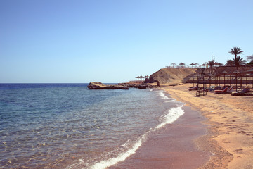 Beach with sun loungers on the seachore
