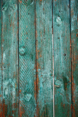 Naklejka premium Old close boarded fence painted with sun-faded green color, textured background with space for your text