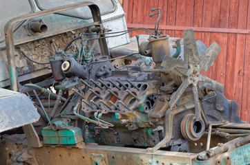 Old outworn disassembled Russian tractor engine with detached cylinder head and visible pistons