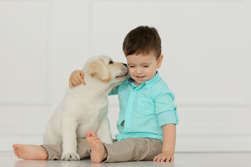 Boy with labrador puppy