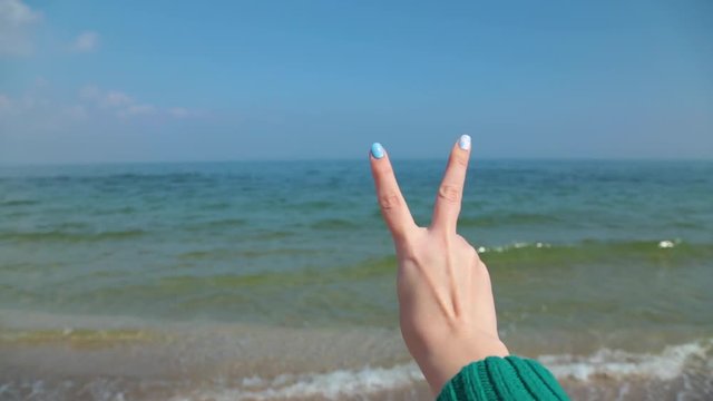 Closeup of isolated female hand counting from 0 to 5. Woman shows fist first, then one, two, three, four, five fingers. Manicured nails painted with beautiful modern blue, white polish. Math concept.