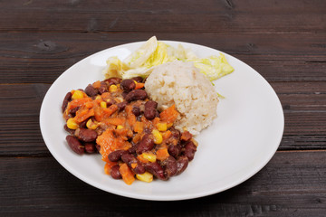 Red beans with corn and carrot, sorghum on a table