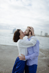 Fototapeta premium A loving couple, man and woman enjoying summer vacation on a tropical paradise beach with clear sea ocean water and scenic