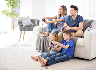 Happy family playing video games at home