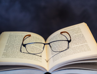 The open book with glasses to symbolize a reading half