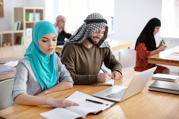 Muslim students wearing traditional clothes in classroom