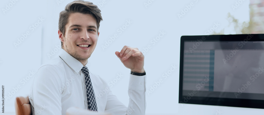 Wall mural employee sitting in front of a computer screen