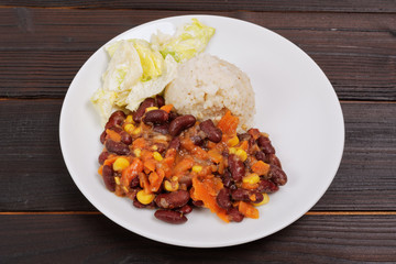 Red beans with corn and carrot, sorghum on a table