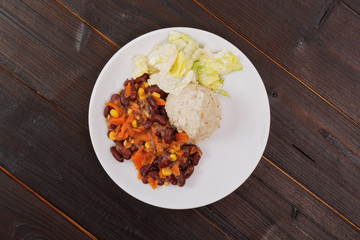 Red beans with corn and carrot, sorghum on a table