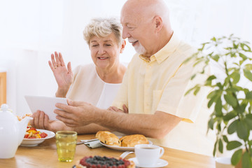 Elder couple watching photos