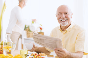 Smiling man with newspaper