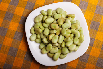 fresh broad beans on a rustic background