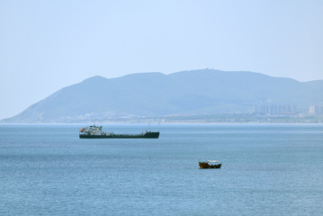 A small pleasure boat and the background of a large ship