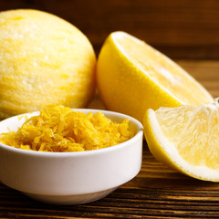Lemon and juice on a wooden background