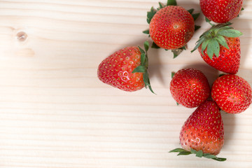 Strawberry fruit.Fresh harvest strawberries with green leaf on wooden table ,top view copy space.