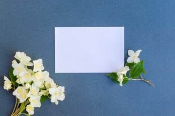 Mockup white greeting card with white jasmine flowers