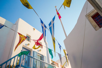 Street with colorful flags in Mykonos, Greece