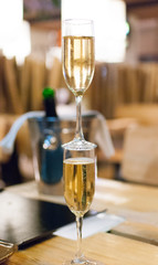 Two wineglasses standing on each other on a table in restaurant