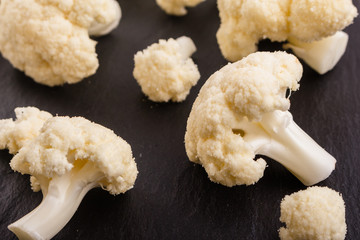 fresh cauliflower on a dark stone background