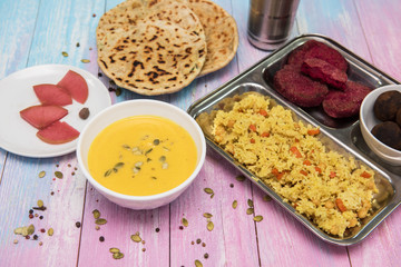 Healthy vegan food: soup with pumpkin seeds, rice with vegetables, beet cutlets, tortillas, compote with pear and chocolate balls