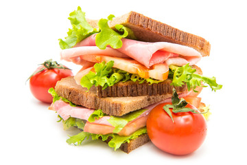 sandwiches with ham, saladf and tomatoes