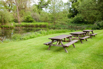 Picnic tables by a pond in Southern England UK