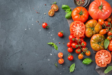 Assortment of ripe organic farmer red tomatoes on a table