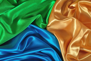 Natural golden, blue and green satin fabric texture