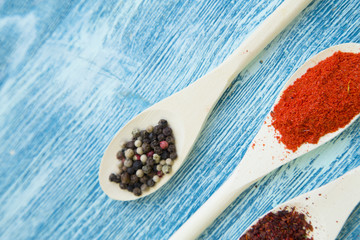 Set of spices and herbs on blue wooden background