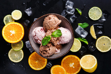 Ice cream scoops in bowl on black background