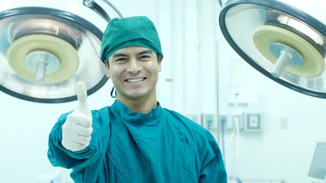 Young man doctor looking to camera with smiling. Medical concept. 
