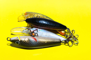 Fishing accessories, Sudak, Russia, April 26, 2018: Spoon-baiters for fishing on a yellow background
