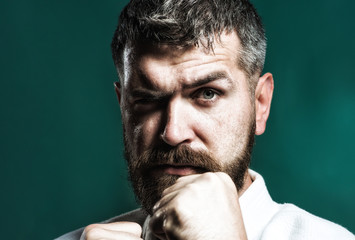 Portrait of bearded man in kimono, closeup. Bearded man dressed in kimono practicing aikido. Brutal...