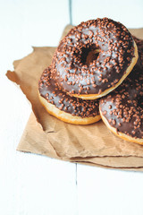 Chocolate donuts and coffee , weekend morning table breakfast. Vintage colors.