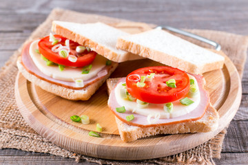 Bread toast with cheese tomato slices and ham