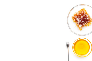 Apiary products. Honey in bowl and honeycomb on white background top view copy space