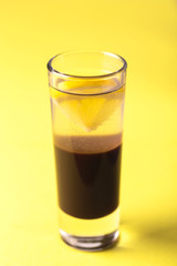 Alcoholic cocktail silver bullet with gin, coffee liqueur and lemon.
