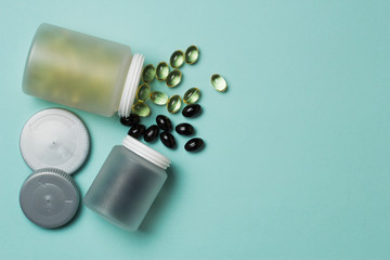 Pills from a bottle on a blue background.