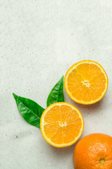 Ripe Juicy Whole and Halved Orange with Green Leaves on White Stone Marble Table. Vitamins Healthy Diet Summer Detox Vegan Tropical Fruits Concept. Poster Banner Template. Copy Space