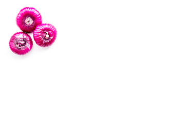 Red onions bulbs on white background top view copy space
