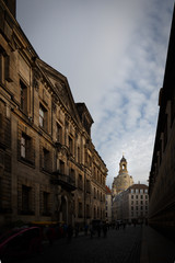 Fototapeta premium Dark Dresden Street with Church of Our Lady Shone on by the Sun