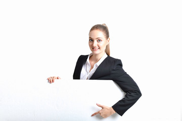 Business Concept. Beautiful businesswoman poses confidently. Young businesswoman pointing on copy space. Beautiful young businesswoman is presenting a job.