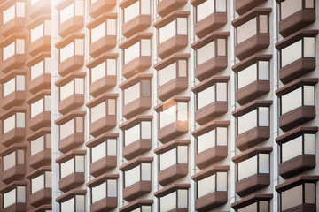 The exterior of condominium windows wit sunlight in the morning