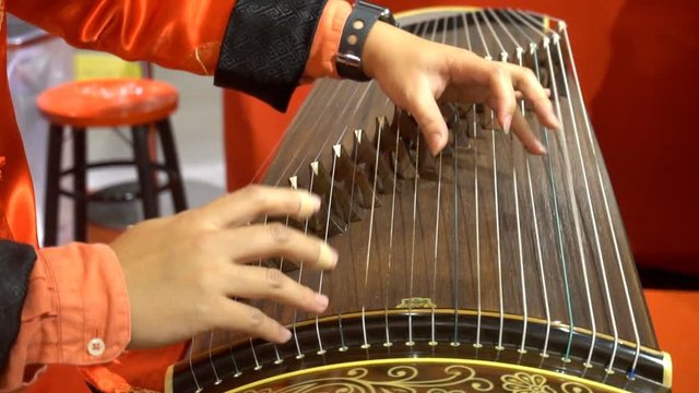 Chinese traditional musician playing Chinese guzheng