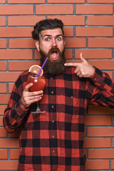 Fototapeta premium Bartender recommends to try beverage. Man in checkered shirt