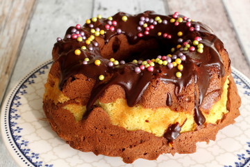 Colorful decorated Childrens Birthday Chocolate Cake on wooden table