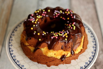 Colorful decorated Childrens Birthday Chocolate Cake on wooden table
