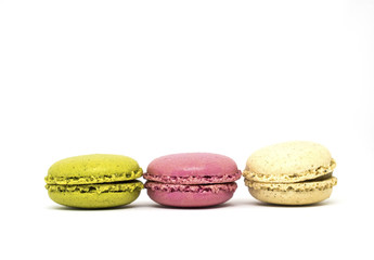 Obraz na płótnie Canvas Three french multicolored macaroon on a white background. Green, pink and cream.